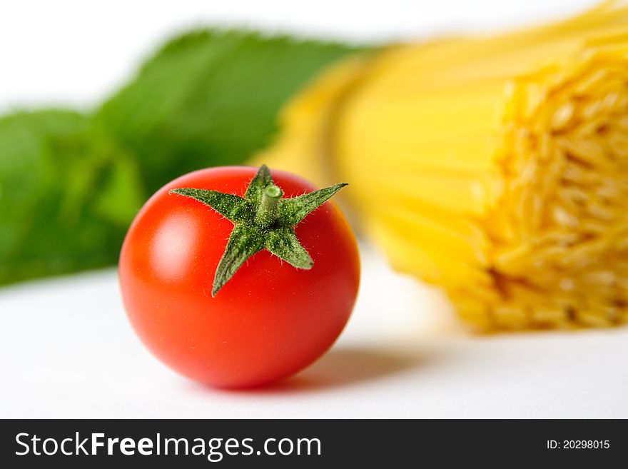 An image of a red tomato and pasta