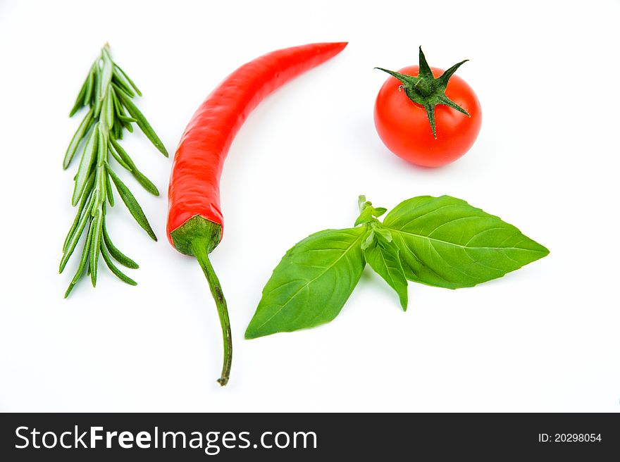 An image of ingredients: rosemary, chili pepper, tomato, basil