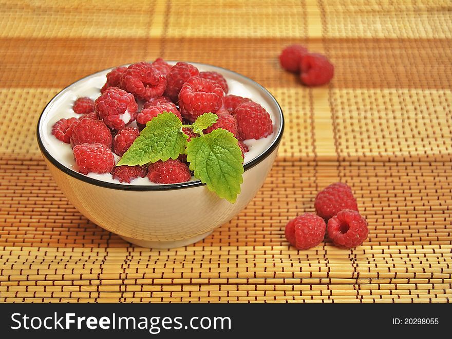 Delicious summer raspberries in milk.