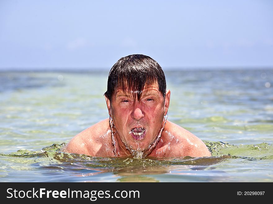 Portrait of a man swimming in the crystal clear ocean. Portrait of a man swimming in the crystal clear ocean