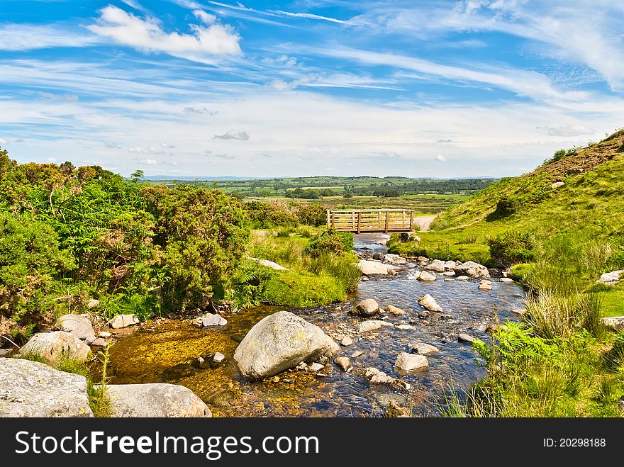 A wooden footbridge on Carrock Beck, Cumbria, in the English Lake District National Park. A wooden footbridge on Carrock Beck, Cumbria, in the English Lake District National Park