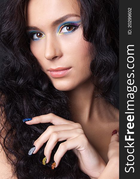 Woman with professional colourful make-up and sparkling manicure isolated on black. Woman with professional colourful make-up and sparkling manicure isolated on black