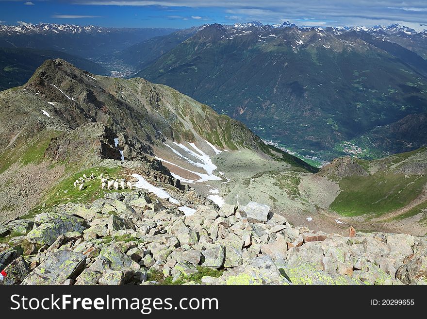 Peak over the village. Varadega Peak at 2634 meters on the sea-level during summer. Brixia province, Lombardy region, Italy. Under the peak a small village