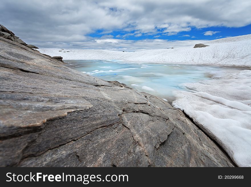 Small icy mountain lakes after a frozen night during summer. Small icy mountain lakes after a frozen night during summer