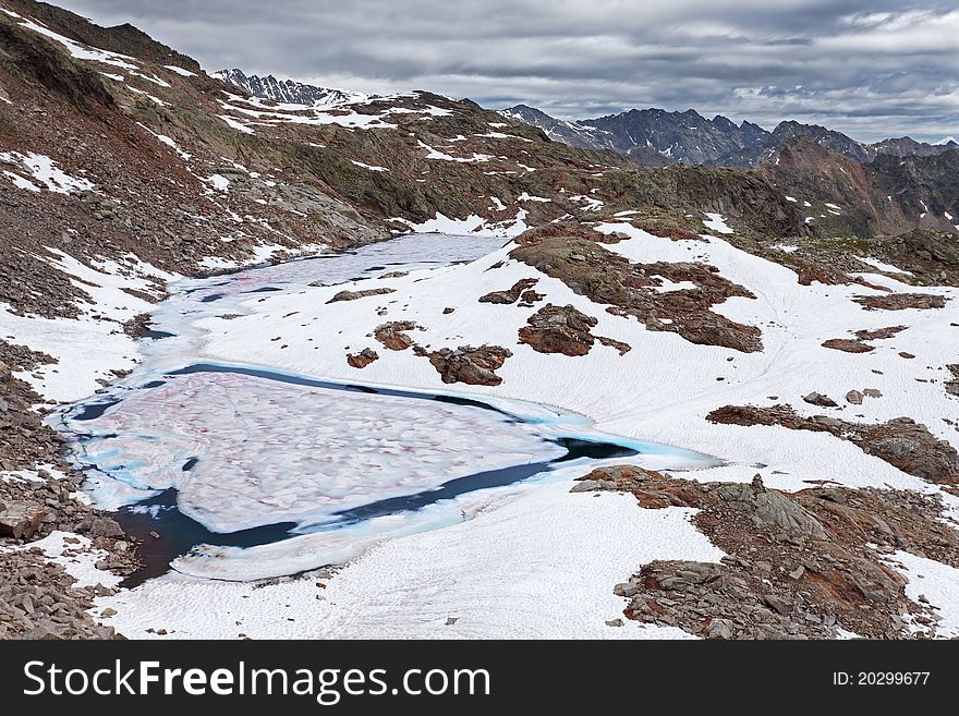 Small icy mountain lakes after a frozen night during summer. Small icy mountain lakes after a frozen night during summer