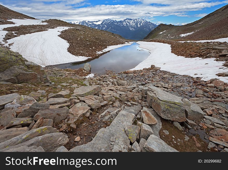 Small icy mountain lakes after a frozen night during summer. Small icy mountain lakes after a frozen night during summer