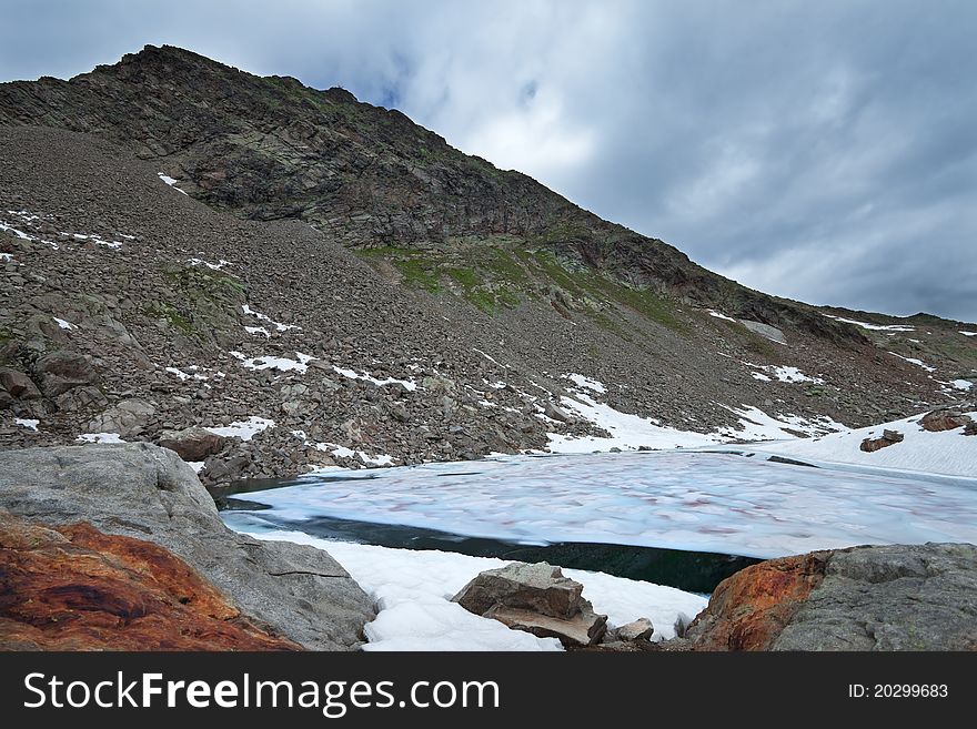 Small icy mountain lakes after a frozen night during summer. Small icy mountain lakes after a frozen night during summer