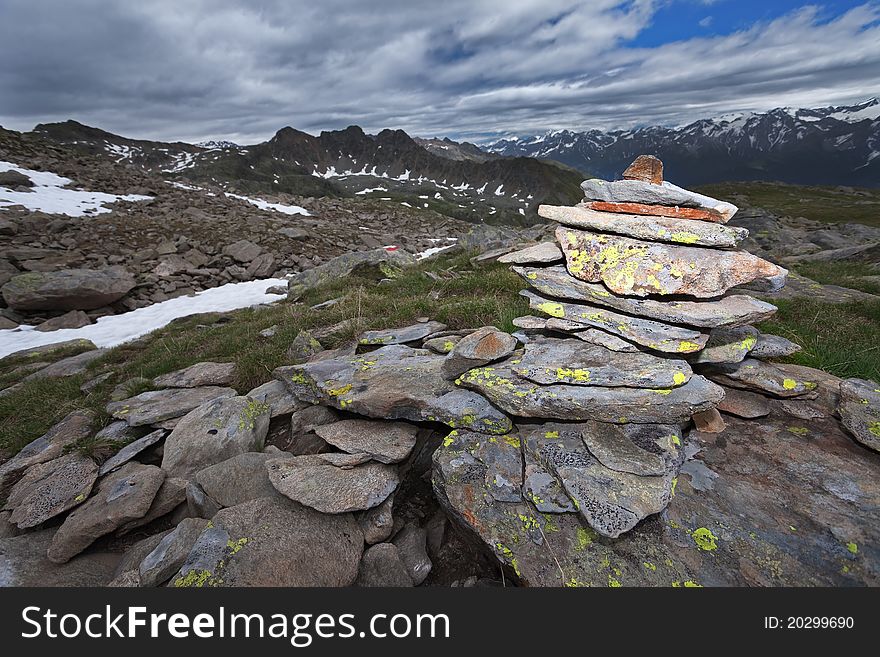 Stone signs for hikers and trekkers at 2.700 meters on the sea-level. Italian Alps