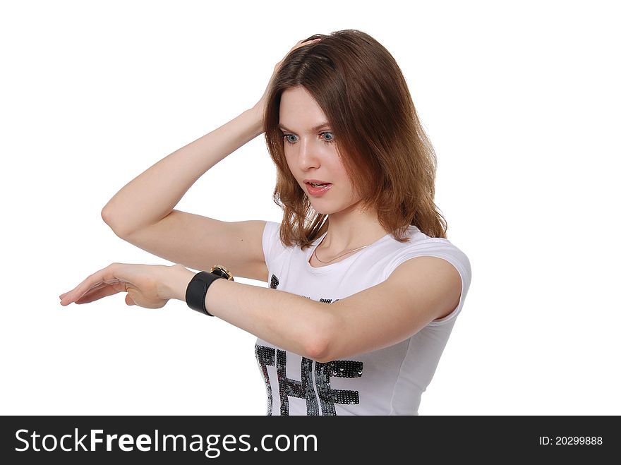 The girl looks at the watch isolated on white background