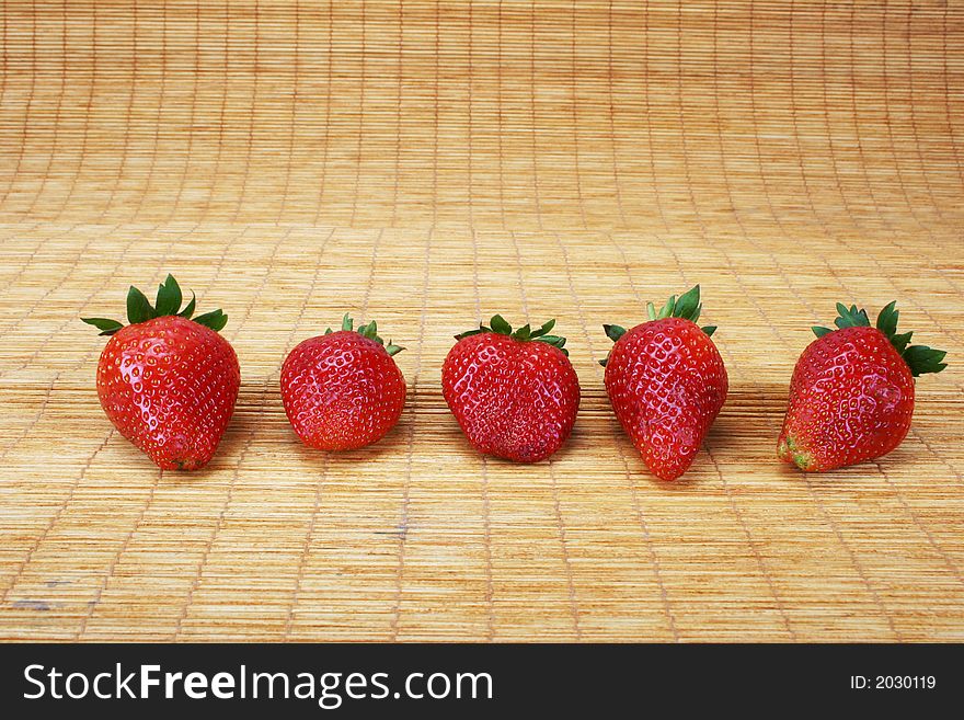 Big red strawberries on a doormat