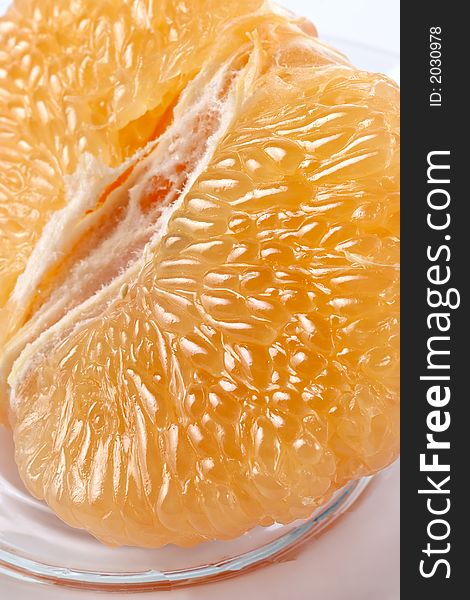 Half of juicy pink grapefruit on a glass plate. Half of juicy pink grapefruit on a glass plate