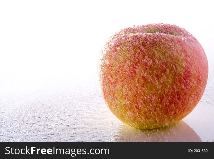 Green fresh apple under rain