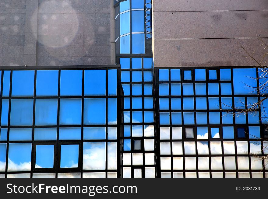 Reflections in blue windows.Modern buildings.