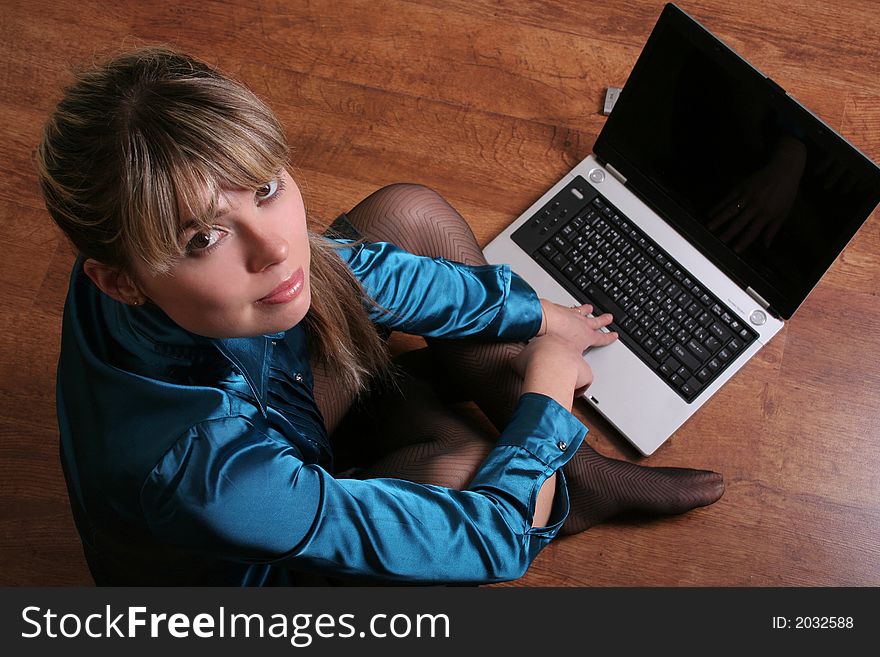 Beautiful girl sitting on floor with laptop. Beautiful girl sitting on floor with laptop.