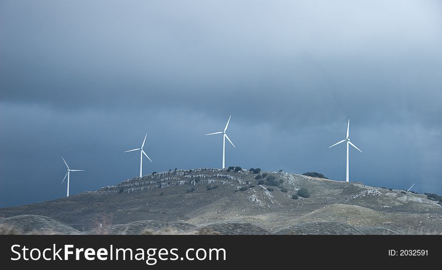 Wind turbines against a dark sky