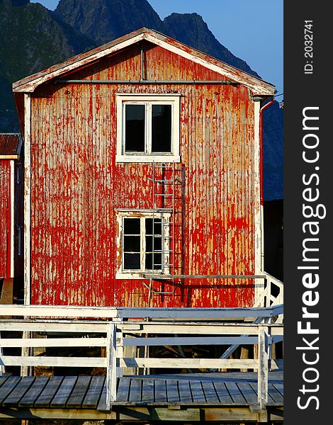 Red wooden house damaged in the lofoten islands