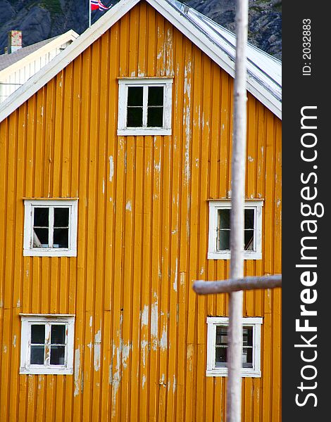 Five windows on a yellow frontage in a typical port of the lofoten islands (norway). Five windows on a yellow frontage in a typical port of the lofoten islands (norway)