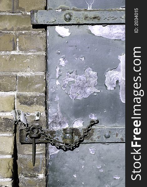 A hasp and staple on an old warehouse door.