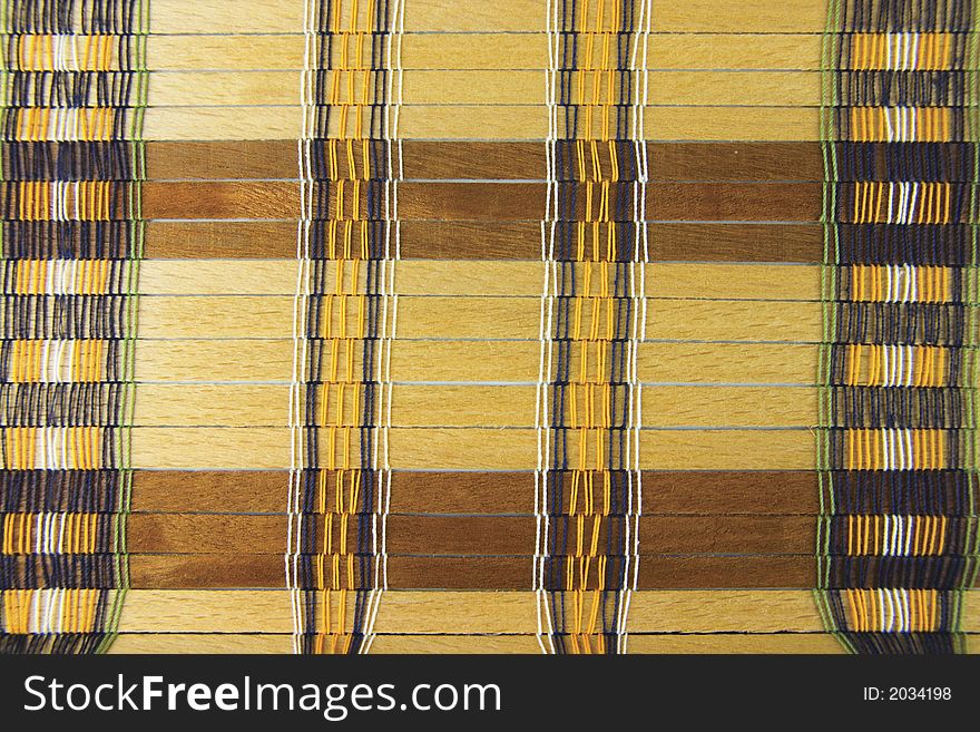 Vintage placemat with natural, unpainted wooden planks and colorful threads - background, texture