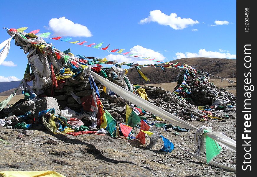 Prayerflags on top of a mountain in Tibet