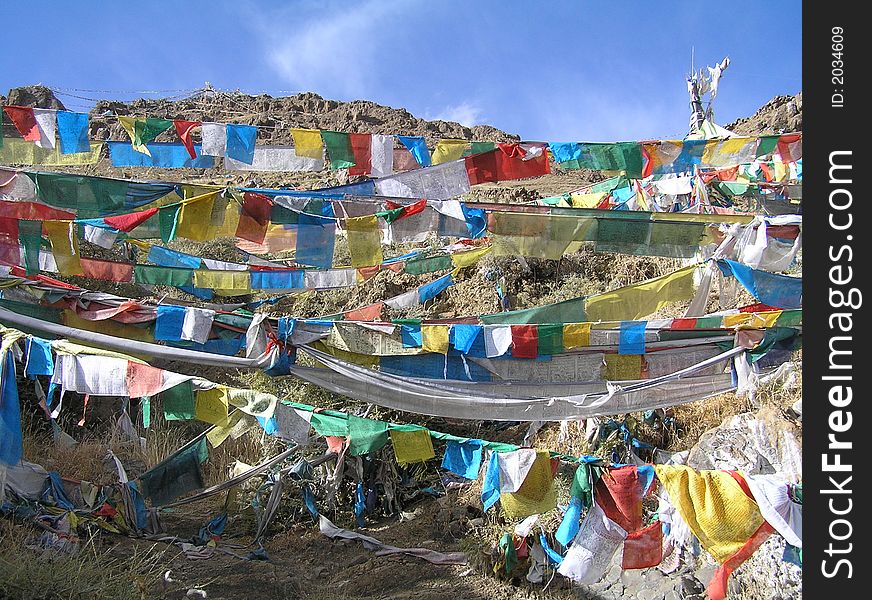 Lot of differnet prayer flags hanging in front of a hill. Lot of differnet prayer flags hanging in front of a hill
