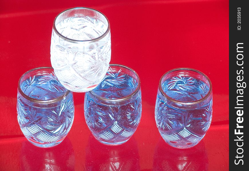 Several blue and white glasses on red background