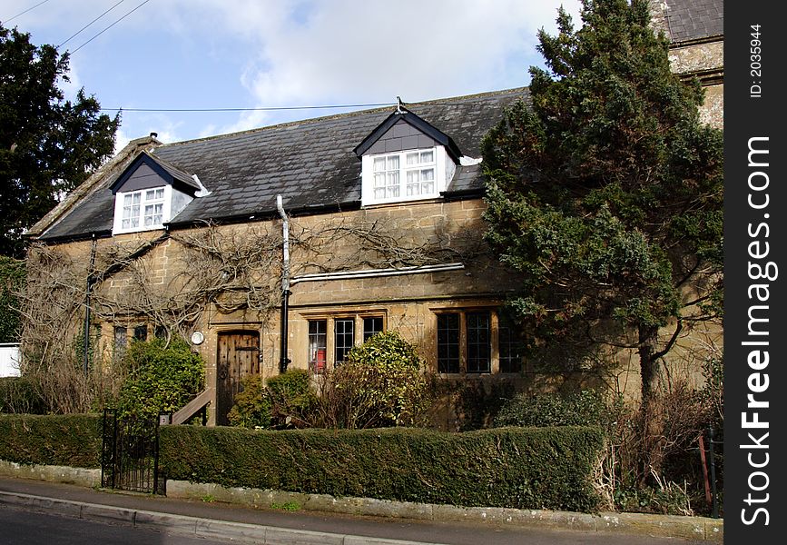 Winter sunshine on a Natural Stone Mullion windowed English Village House