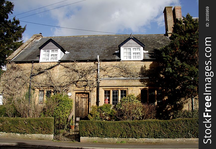 Winter sunshine on a Natural Stone Mullion windowed English Village House