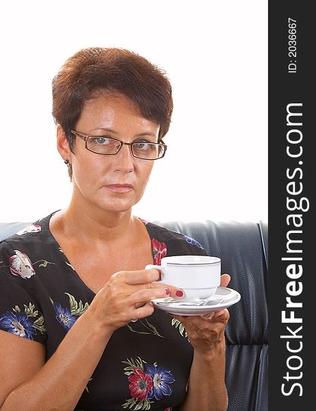 View of a woman on the sofa   drinking some coffee. View of a woman on the sofa   drinking some coffee