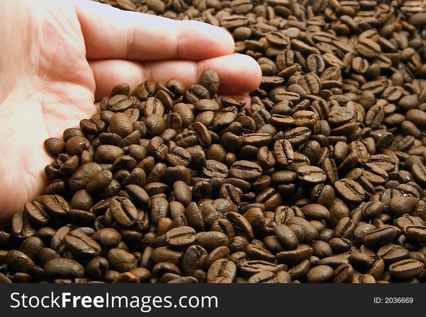 Hand with coffee beans background