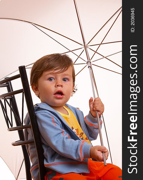 View of nice young boy with umbrella expecting the rain coming. View of nice young boy with umbrella expecting the rain coming