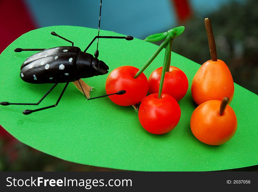 Beetle and cherry made out of plasticine in Sichuan,west of China. Beetle and cherry made out of plasticine in Sichuan,west of China