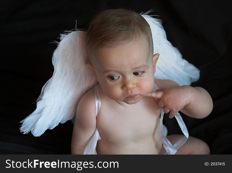 Image of baby wearing angel wings. Image of baby wearing angel wings