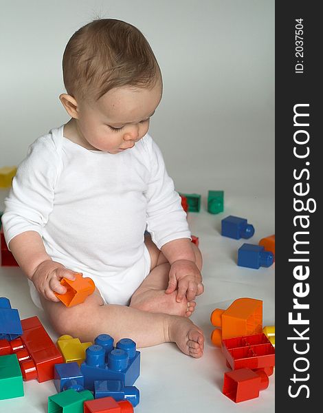 Image of cute baby playing with colorful building blocks. Image of cute baby playing with colorful building blocks