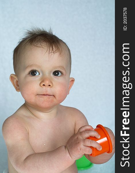 Image of adorable baby playing with stacking cups. Image of adorable baby playing with stacking cups