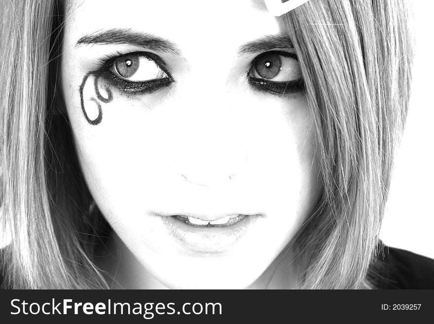 A black and white high-key picture of teenager with decorative make-up. A black and white high-key picture of teenager with decorative make-up