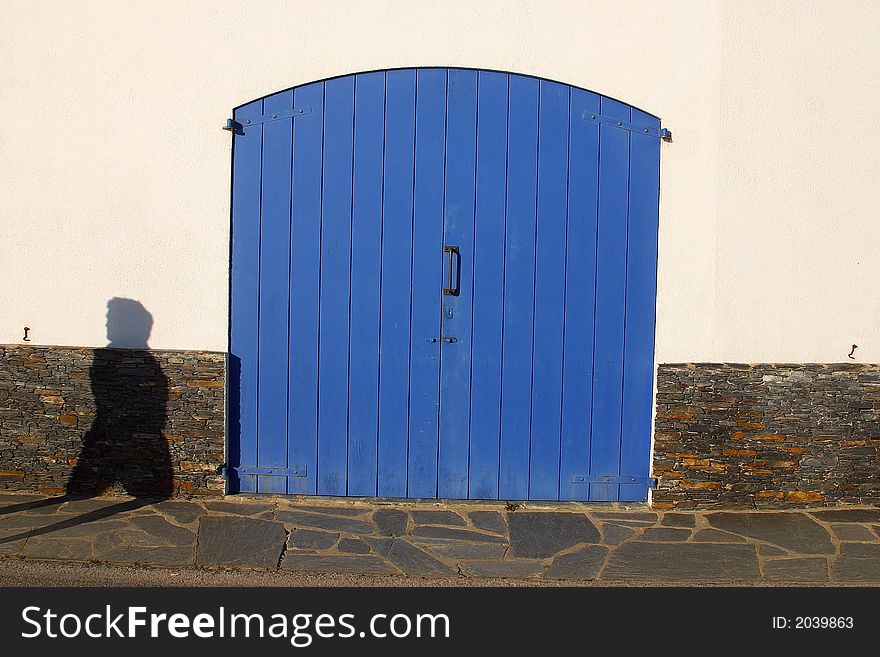 Blue door with shadow infront