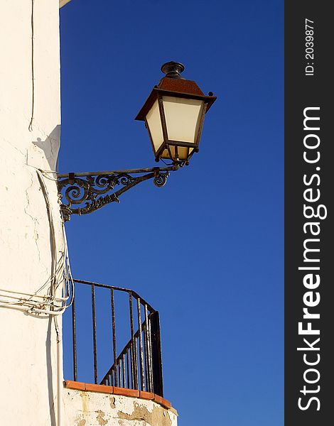 Old street lamp at a corner of the town of Cadaques, Catalonia, Spain, Europe. Old street lamp at a corner of the town of Cadaques, Catalonia, Spain, Europe