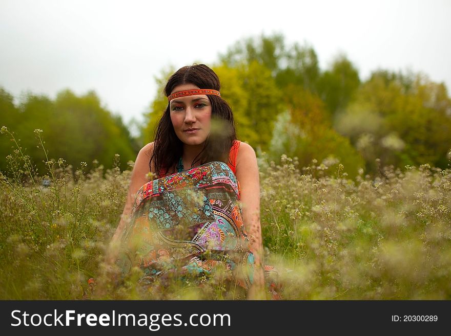 Girl Sitting In An Autumn Field