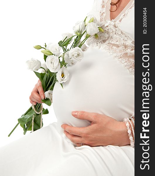 Pregnant woman caressing her belly over white background