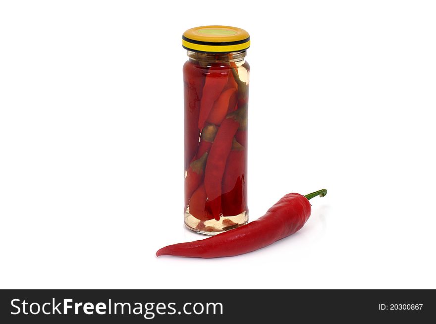 Preserved red hot pepper in glass jar on white background. Preserved red hot pepper in glass jar on white background