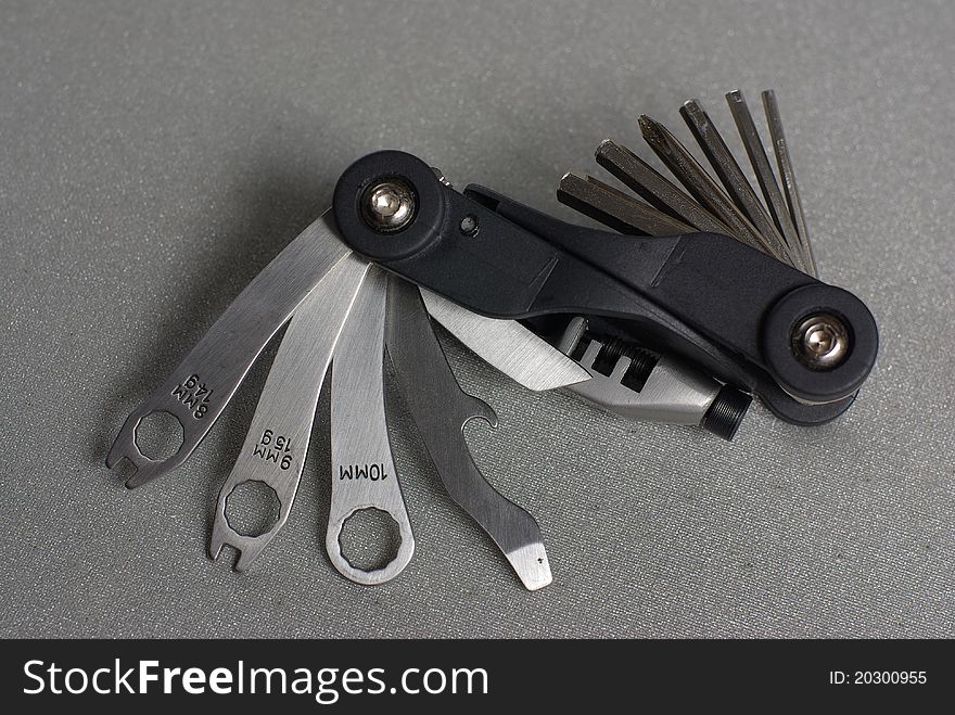 Black multifunctional bike tool on grey. Black multifunctional bike tool on grey