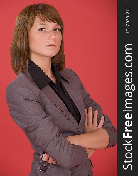 Portrait of serious businesswoman over red background
