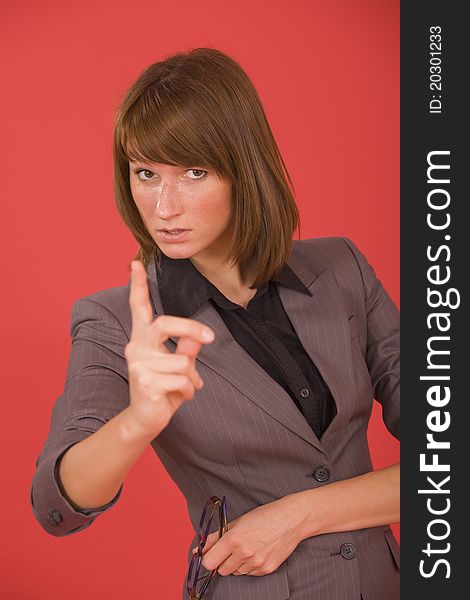 Business woman pointing with finger over red background