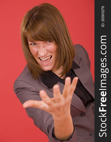 Frustrated woman in grey suit over red background