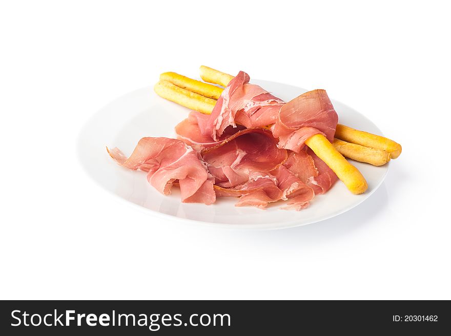 White plate with slices of Italian ham from Parma. White plate with slices of Italian ham from Parma