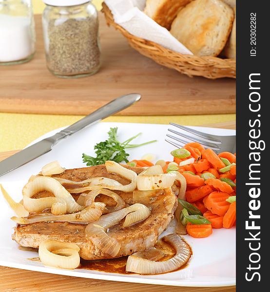 Pork loin dinner with onions and carrots