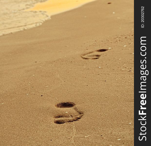 Footsteps on the beach, in the sunset