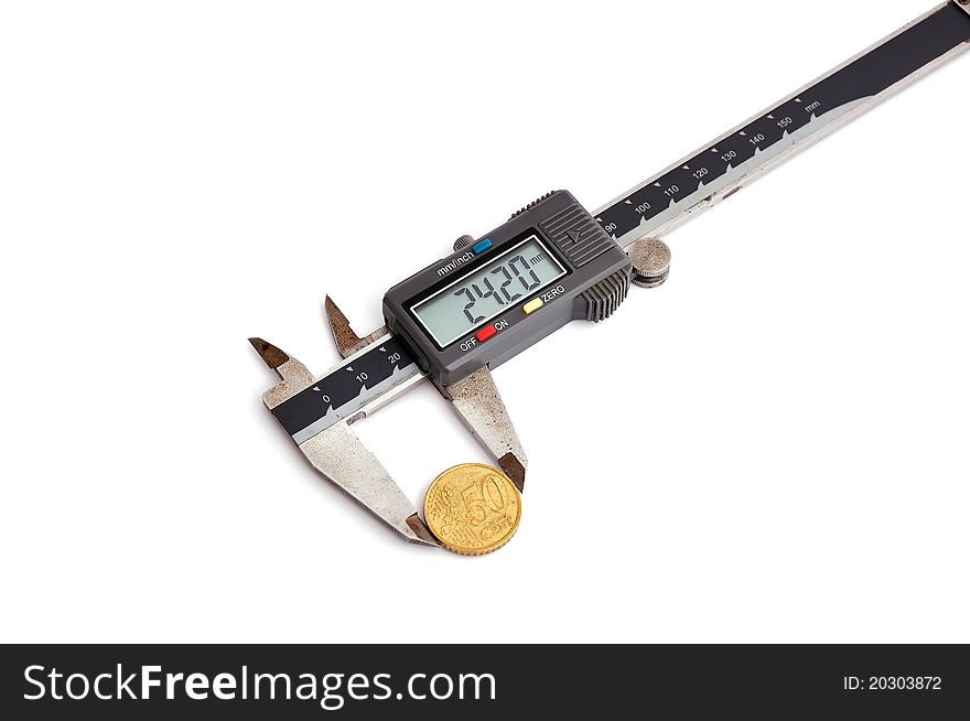 Electronic calipers and coin on a white background