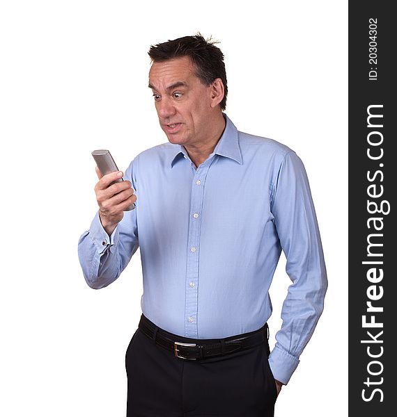 Attractive Middle Age Man in Blue Shirt Looking at Phone with Startled Expression. Attractive Middle Age Man in Blue Shirt Looking at Phone with Startled Expression